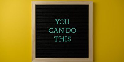 Inspirational message 'You Can Do This' displayed on a blackboard with a bold yellow backdrop.